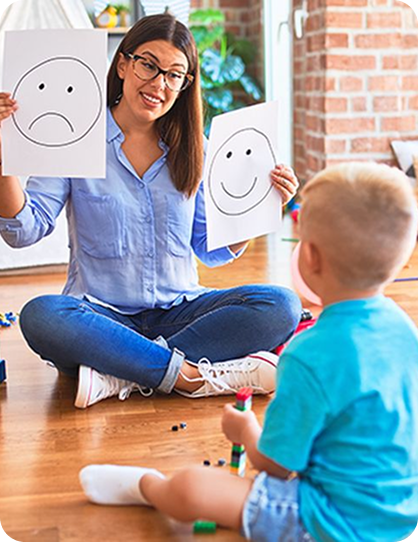 Coach showing emotion cards to a young child