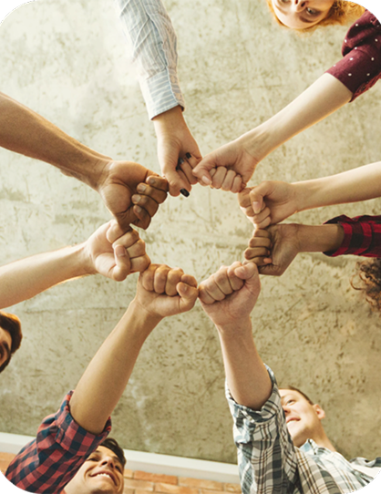 Group of hands joined in a circle of fist bumps