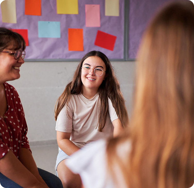 Young adult chatting with friends in a group setting