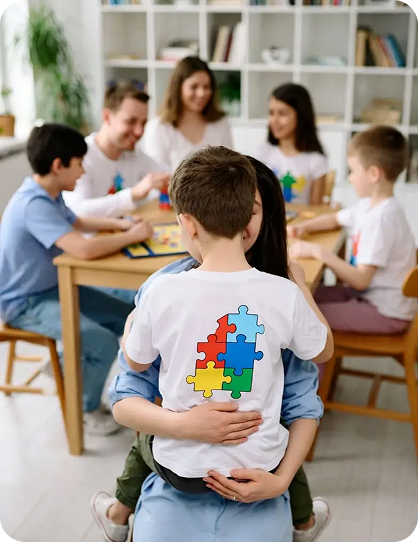Children in a classroom, one wearing a puzzle-piece shirt