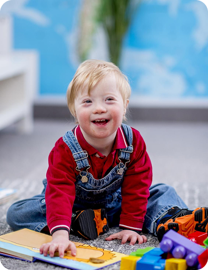 Smiling young child playing with blocks