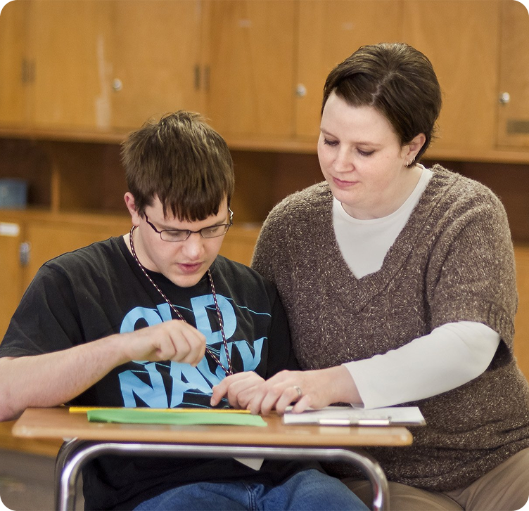 Young adult working through schoolwork with a parent